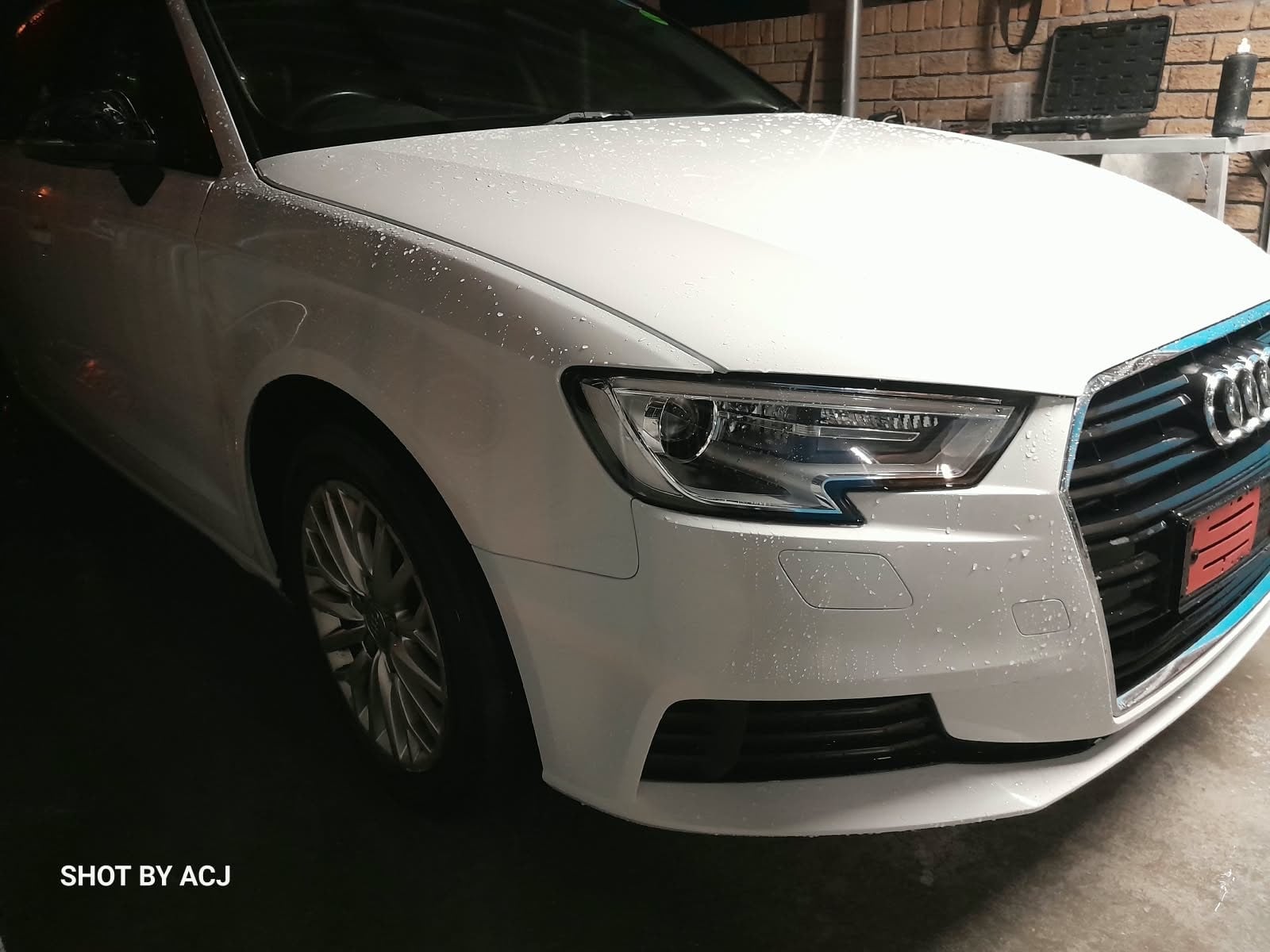 White Audi front-right headlight and wing after ACJ repair