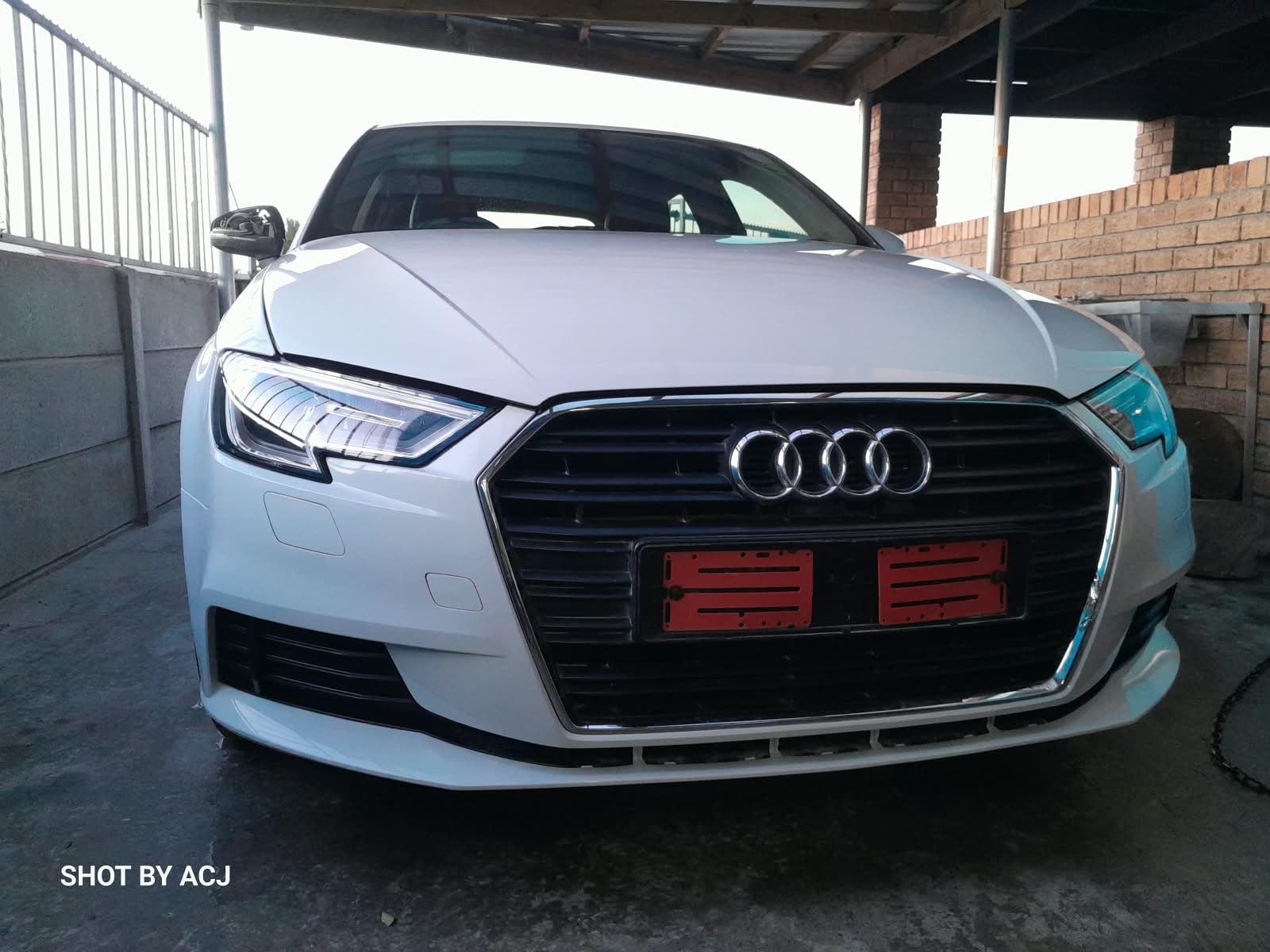 White Audi front grille and headlights after ACJ repair